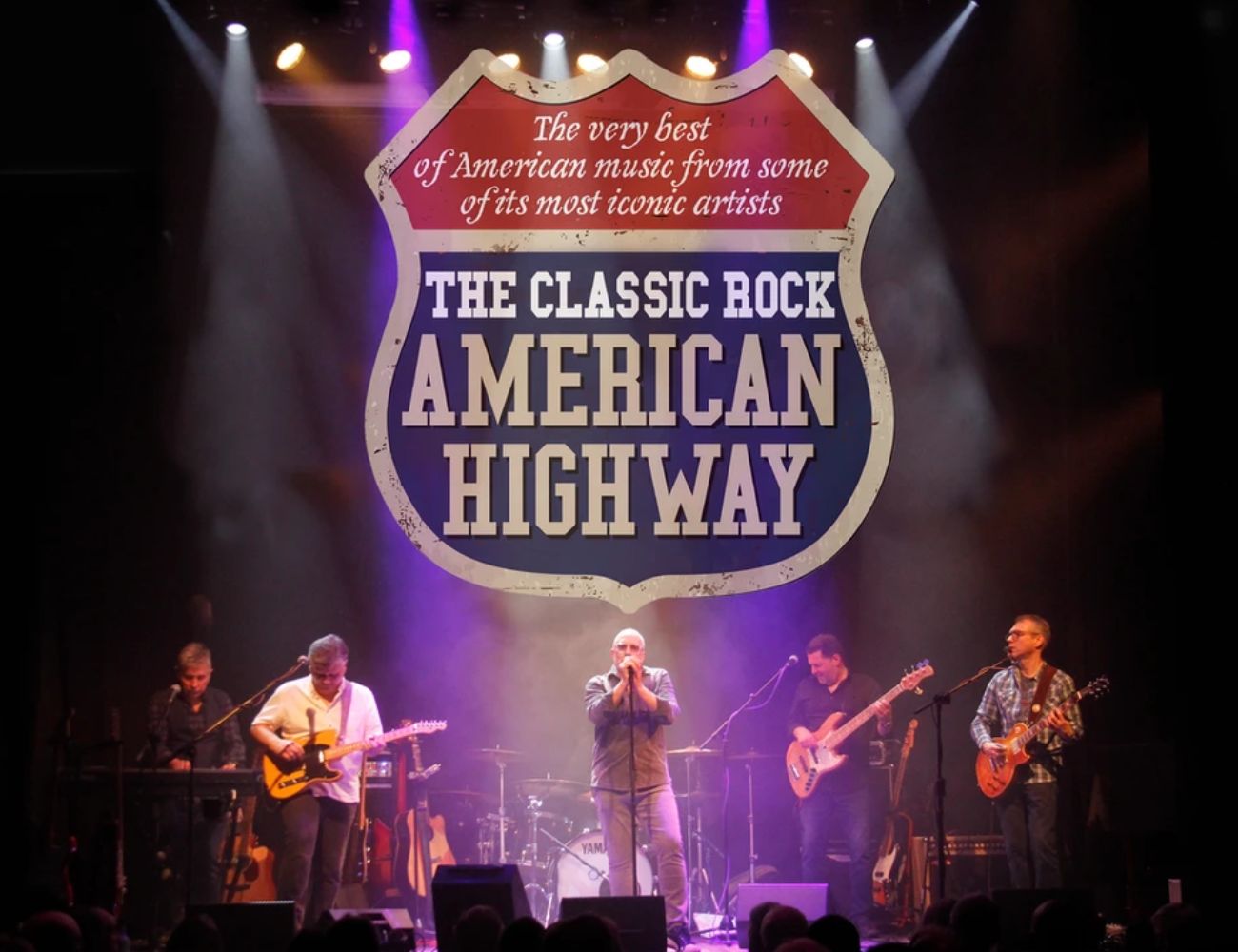 Rock band performing on stage. Text reads The Classic Rock American Highway